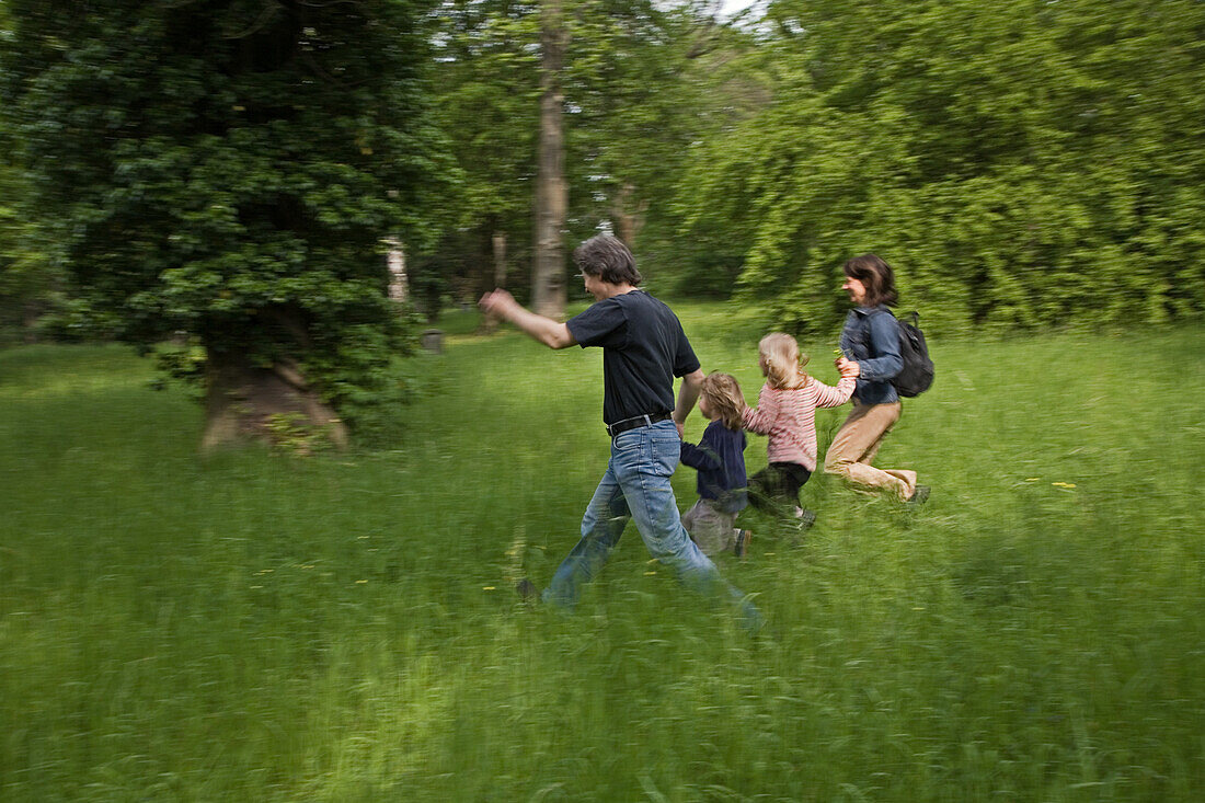 young family running through grass in forest, park, MR