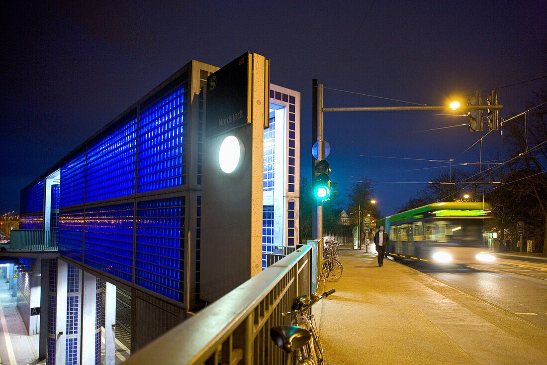 Bus passing S-bahn station Nordstadt at night, Hanover, Lower Saxony, Germany