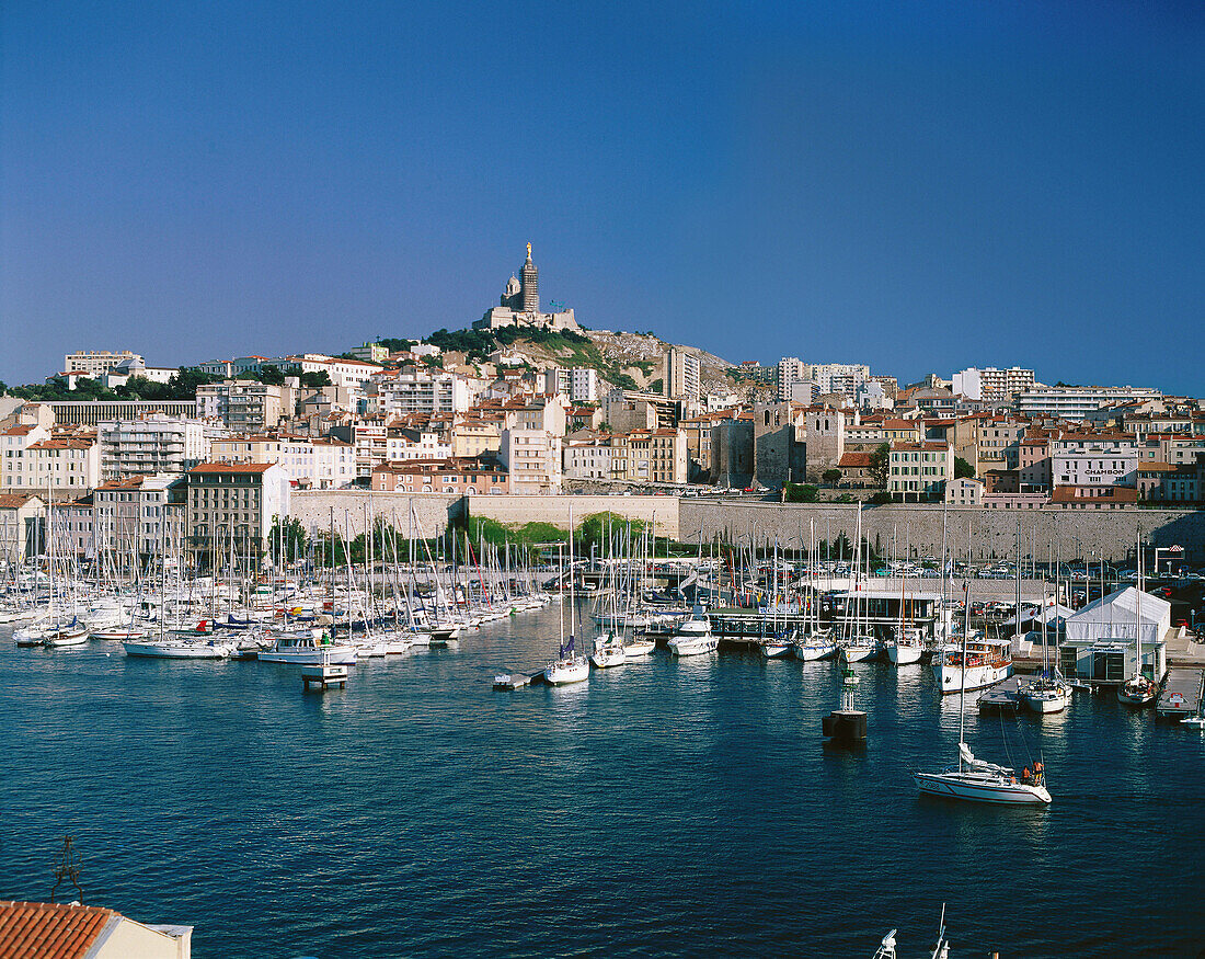 Old harbour. Church of Notre Dame de la Garde on the top of the hill. Marseille. France