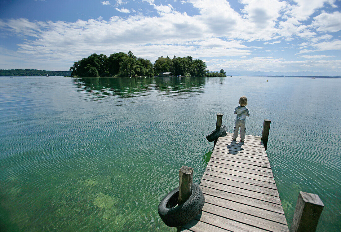 Boy on jetty, view to Rose Island, Possenhofen, Lake Starnberg, Bavaria, Germany