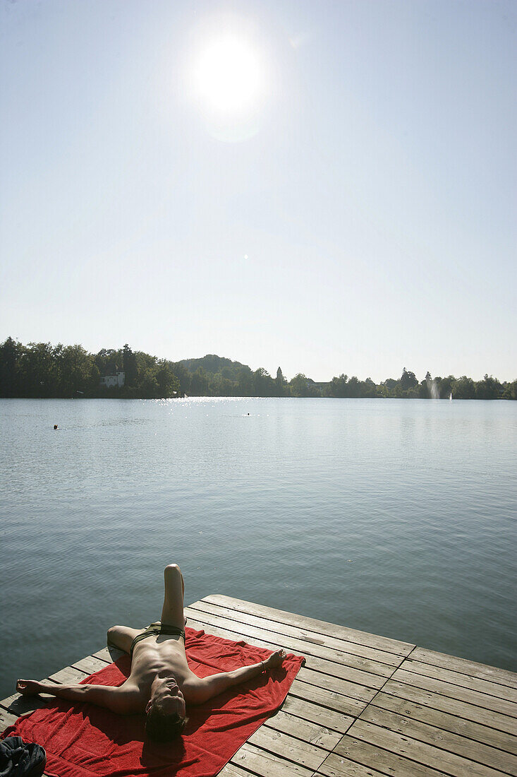 Man sunbathing on a jetty, Lake, Wesslinger See, Upper Bavaria, Bavaria, Germany