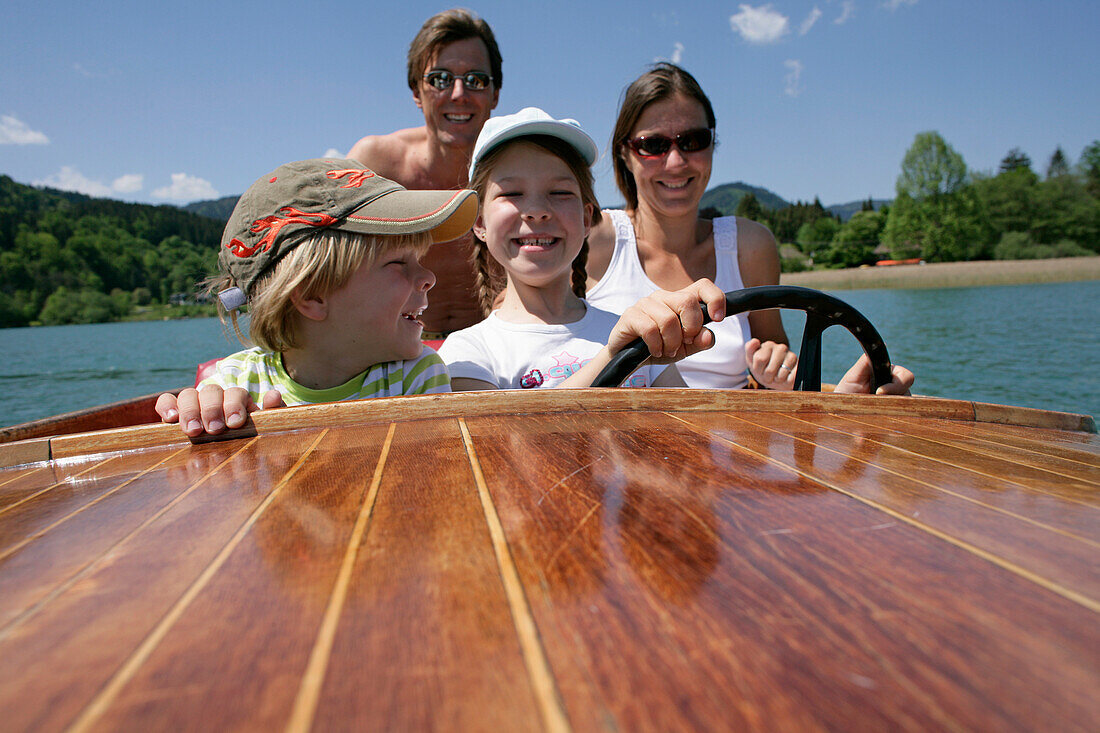 Family in electric rental boat, Lake Tegernsee, Upper Bavaria, Bavaria, Germany, MR