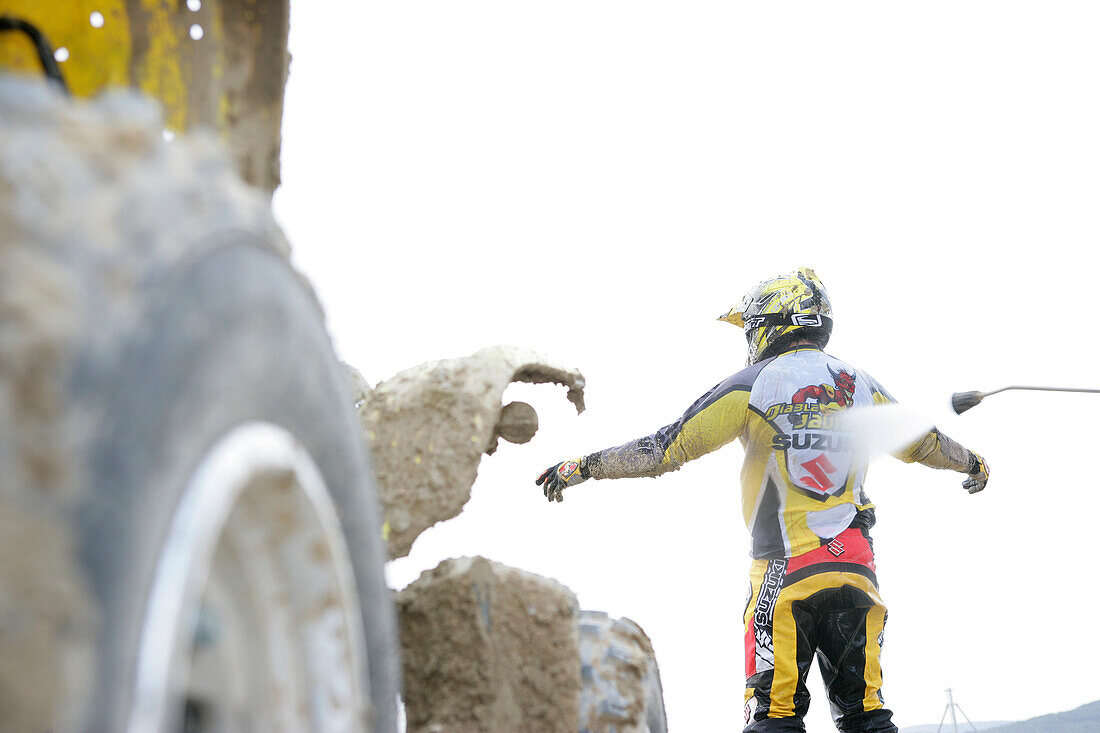 Man being hosed down after riding quad, Suzuki Offroad Camp, Valencia, Spain