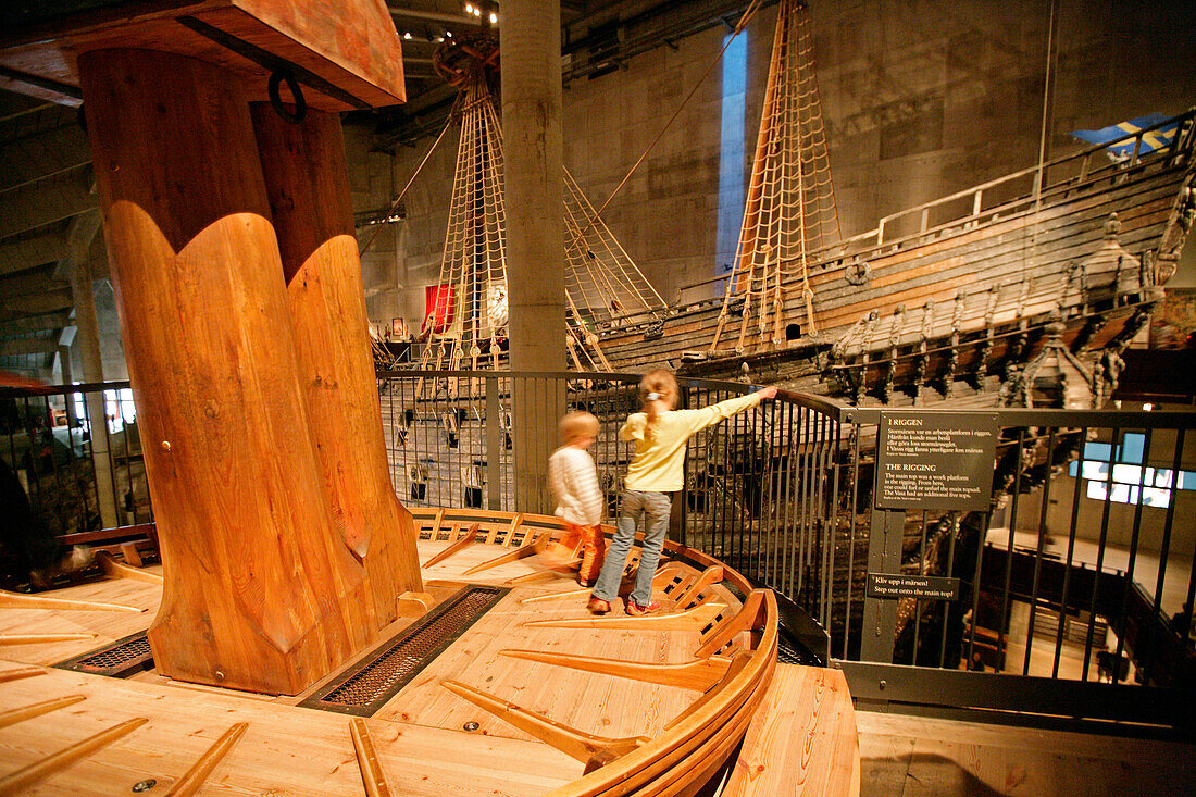 Two children standing on a ship in the Vasa Museum, Stockholm, Sweden