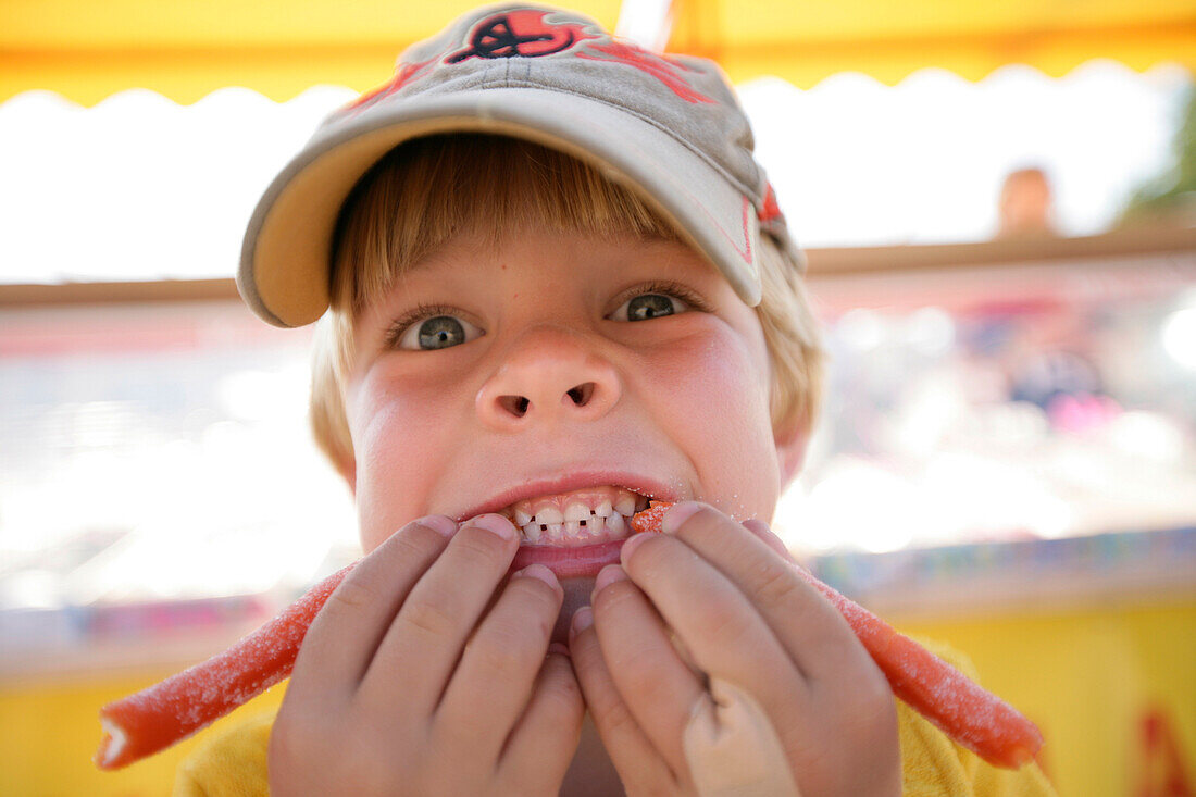 Boy eating candy, typical liquorice, Visby, Gotland, Sweden