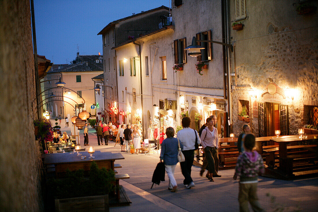 People walking down an alley in the old town, Castiglione della Pescaia, Maremma, Tuscany, Italy