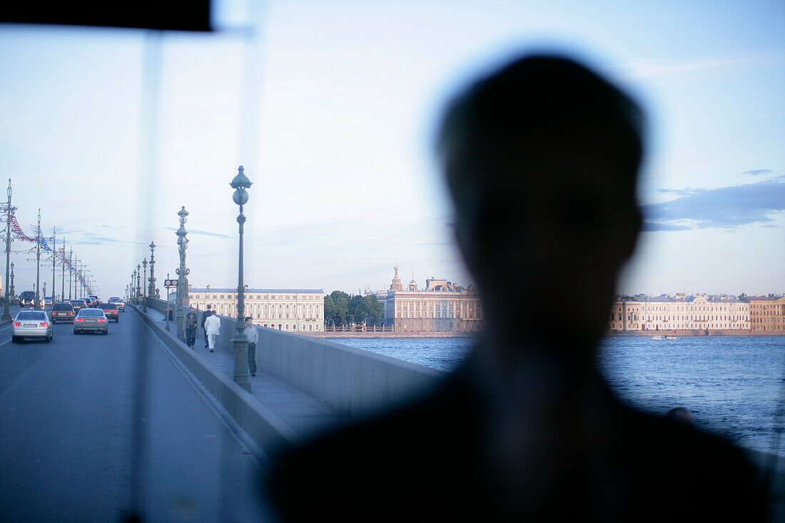 View out of a tour bus, bus driving across river Newa during white midsummer night, St. Petersburg, Russia