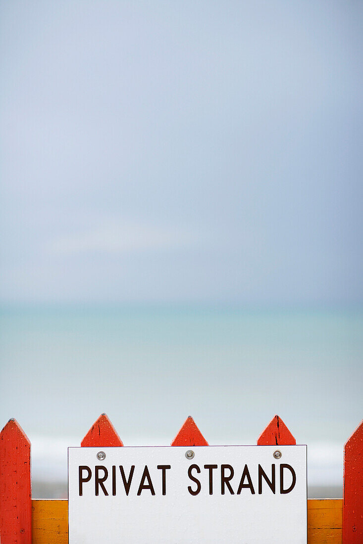 Sign on a fence of a private beach, North Sea, Germany