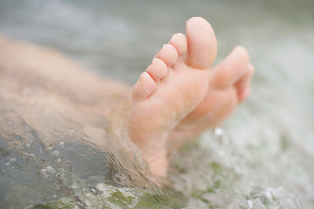 Woman's feet lying in a swimming pool, Bavaria, Germany, MR