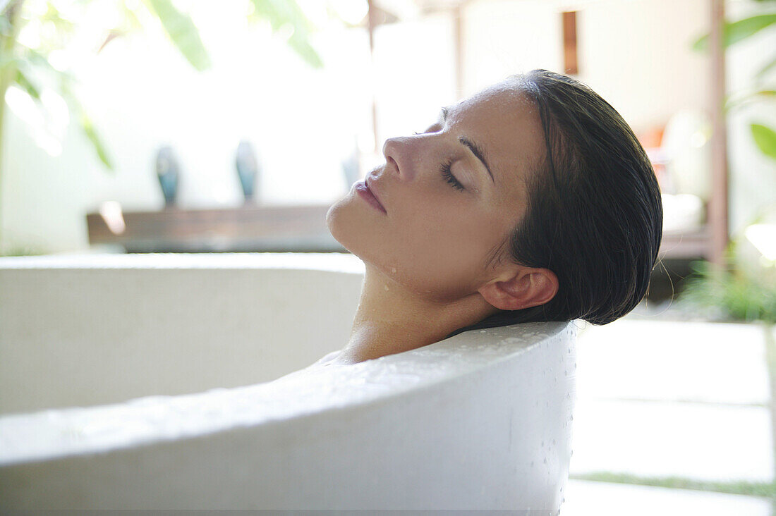 Mid adult woman relaxing in bathtub, Styria, Austria