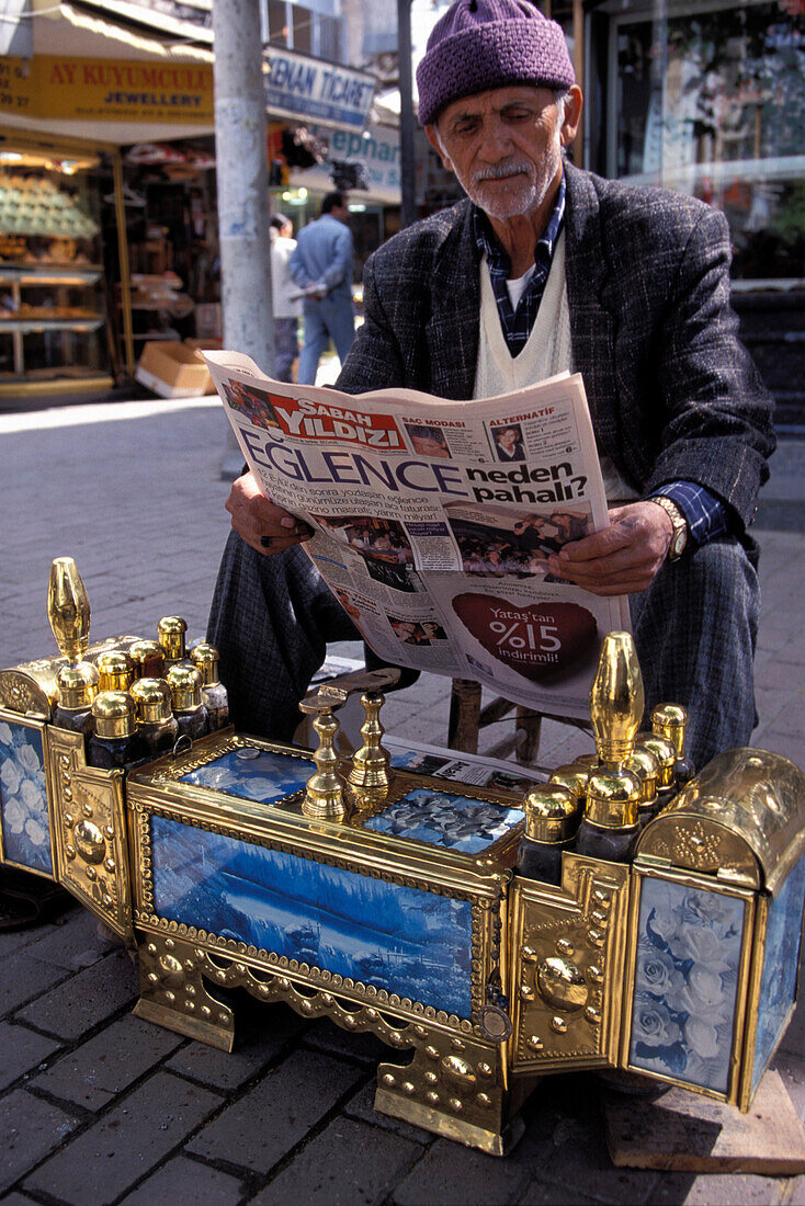 Shoeblack reading newspaper, Antalya, Turkish Riviera, Turkey