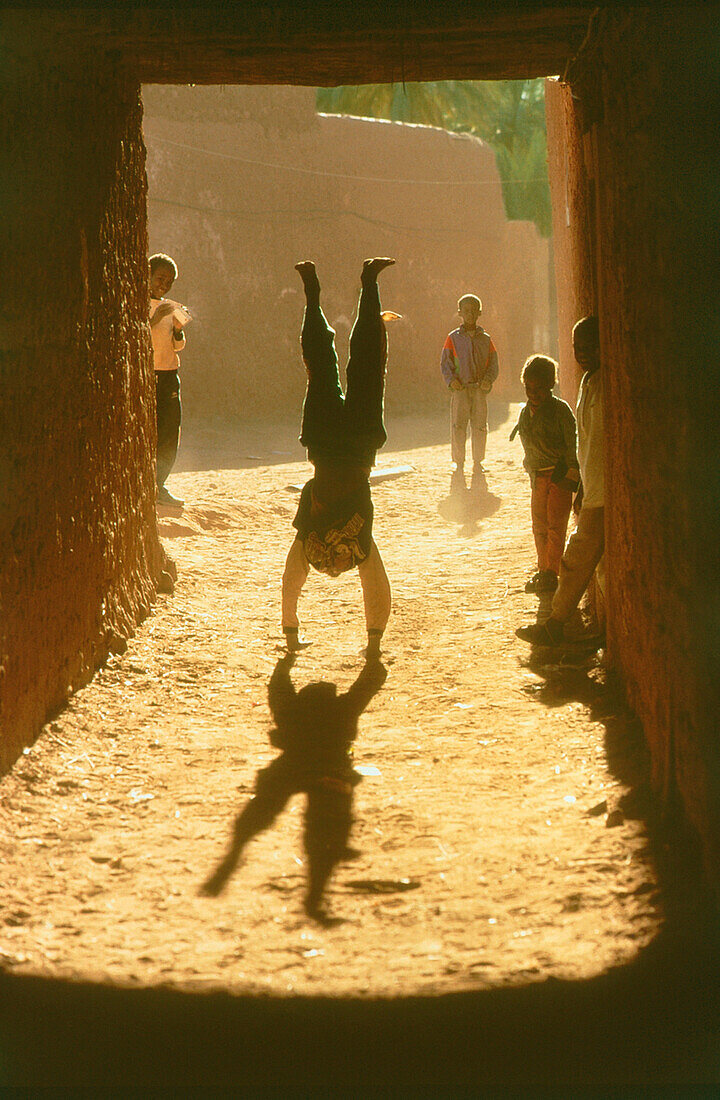 Boy doing handstand, Algeria, Africa