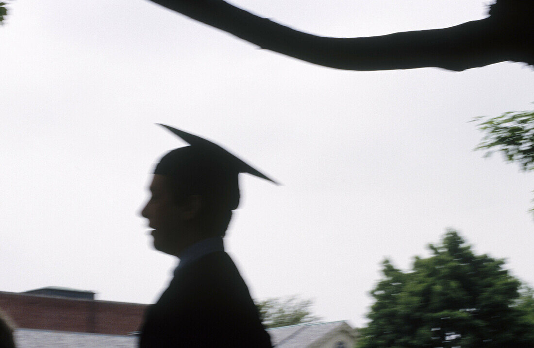 Silhouette of graduate during commencement ceremony. USA