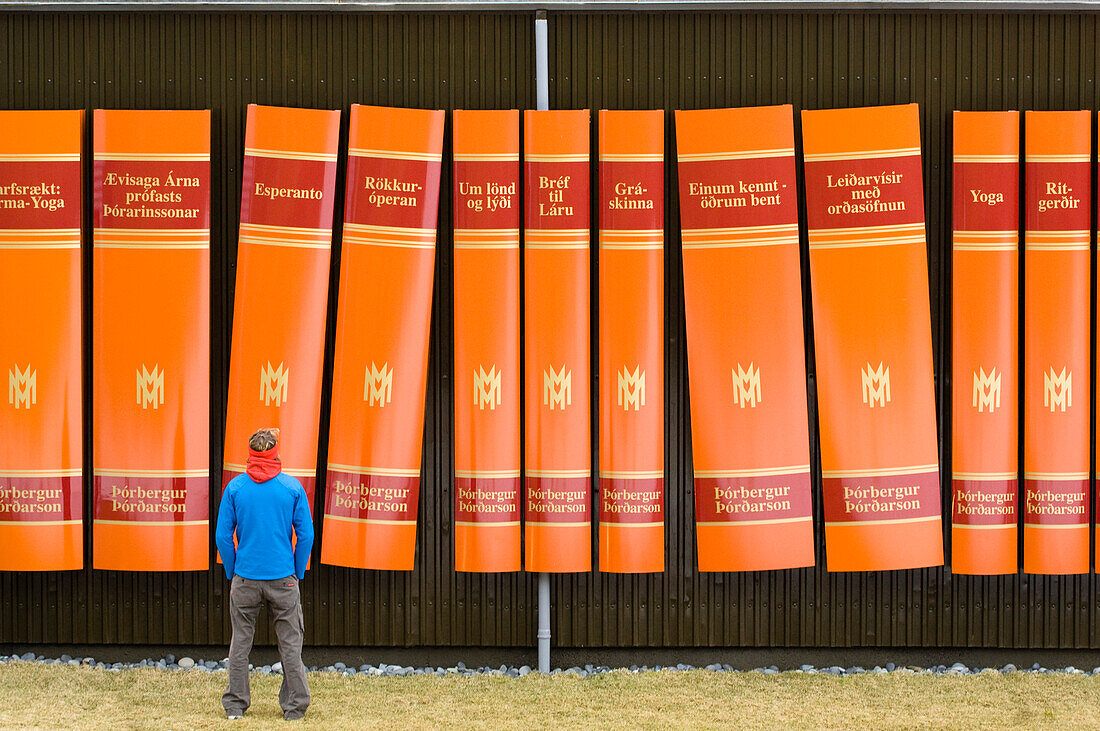 Man in front of giant book poster, Iceland