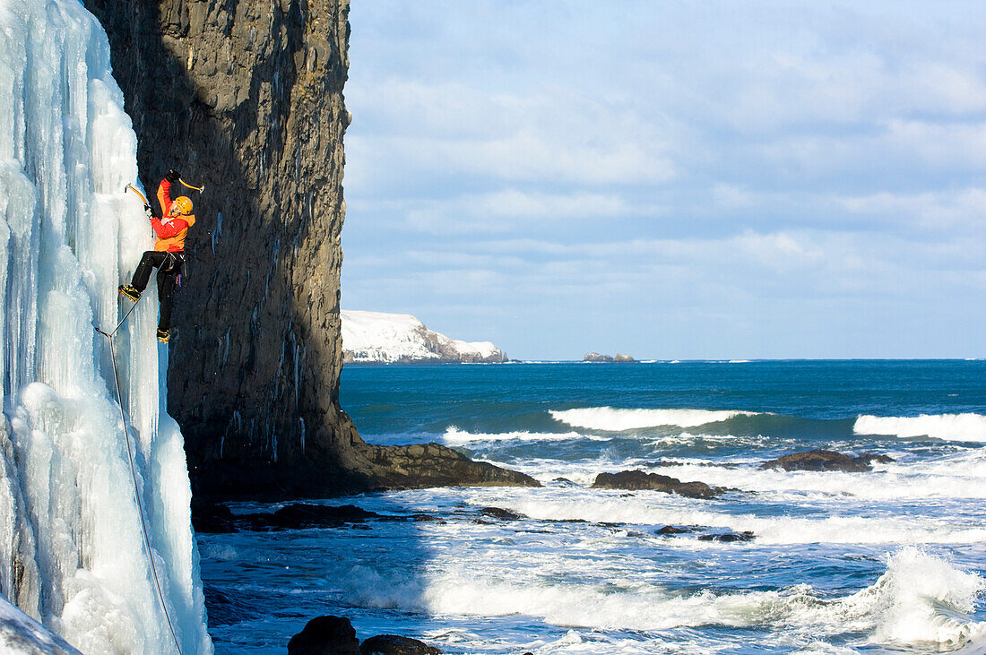 Ice climber at coast, Iceland