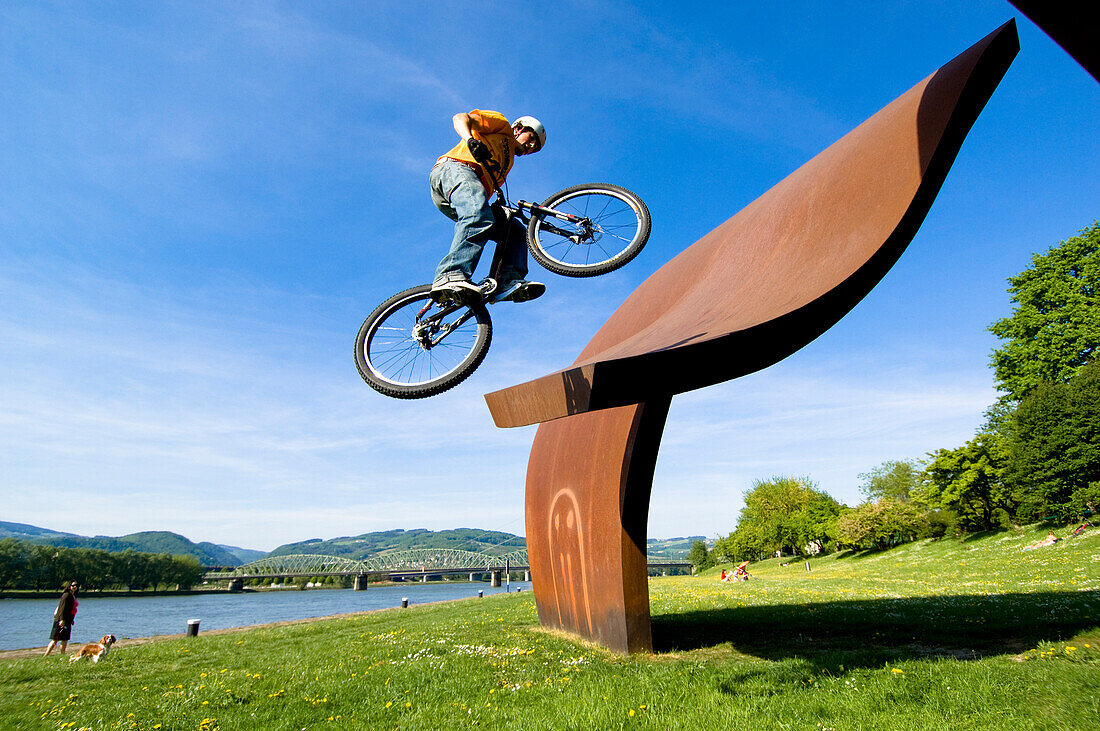 Man trial biking on sculpture in park, Linz, Upper Austria, Austria