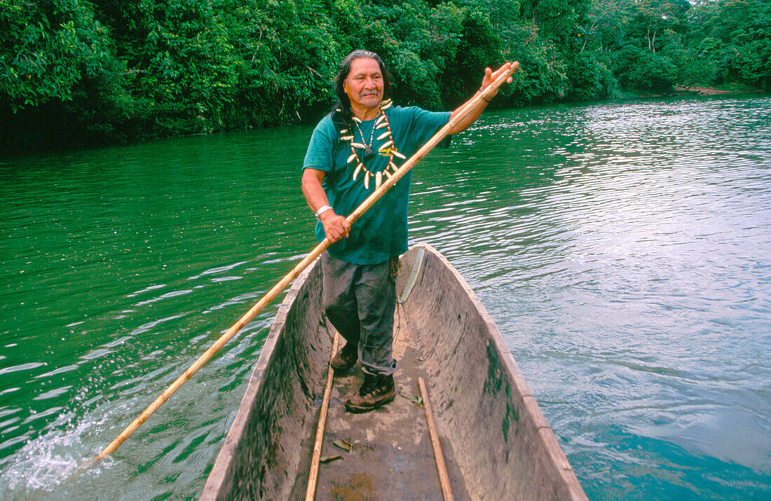 Shaman Vargas sailing in a canoe by the Puyo river. Indi Churis community. Pastaza province. Ecuador