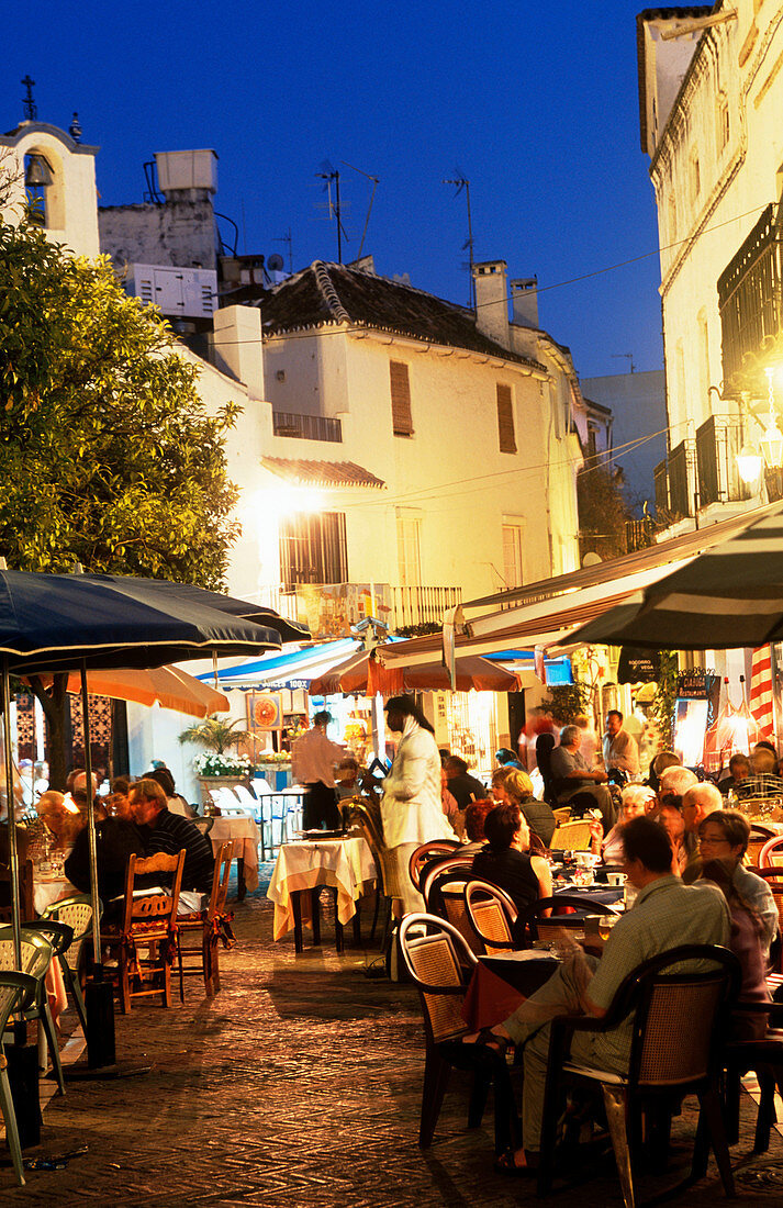 Outdoor cafes in Plaza de los Naranjos in old town at night. Marbella. Malaga province. Costa del Sol. Andalucia. Spain