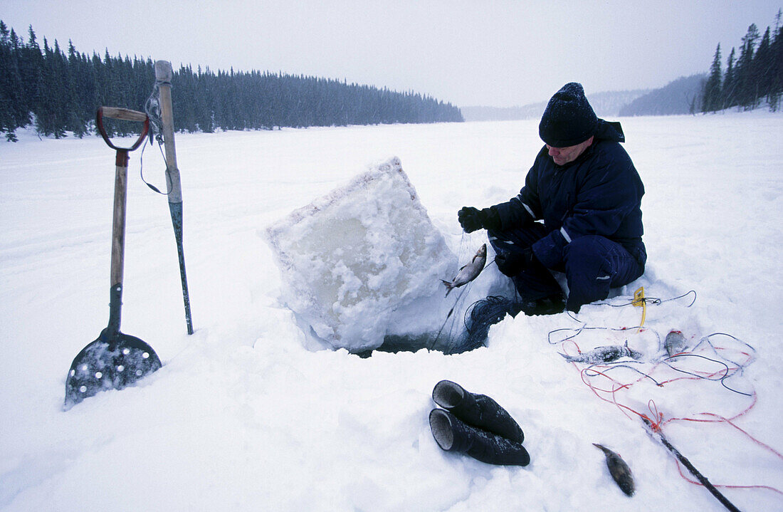 Fishing in iced lakes. Kuusamo. Finland.