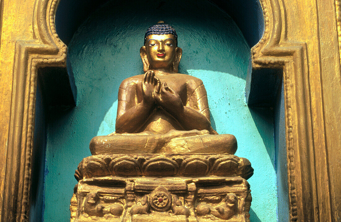 Gilded buddha in enlightenment position (this posture is commemorative of the first sermon preached by Gautama Buddha at the deer park in Sarnath). Near Mahabodhi Temple. Bodhgaya. Bihar State. India