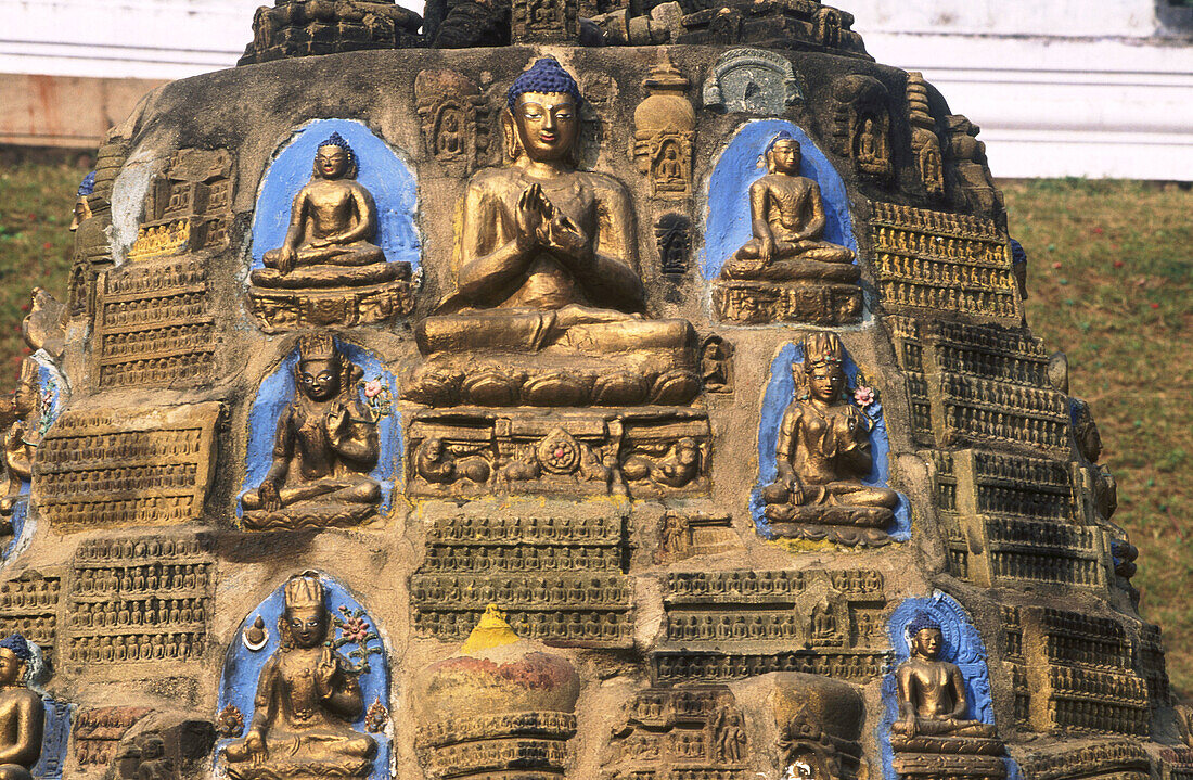 Lord buddha in the fuming the wheel or turning the wheel of law posture (teaching gesture) on a votive stupa in front of Mahabodhi Temple. Bodhgaya. Bihar State. India