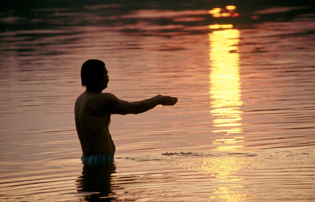 Offering to sun god in Narmada River, Jabalpur. Madhya Pradesh, India