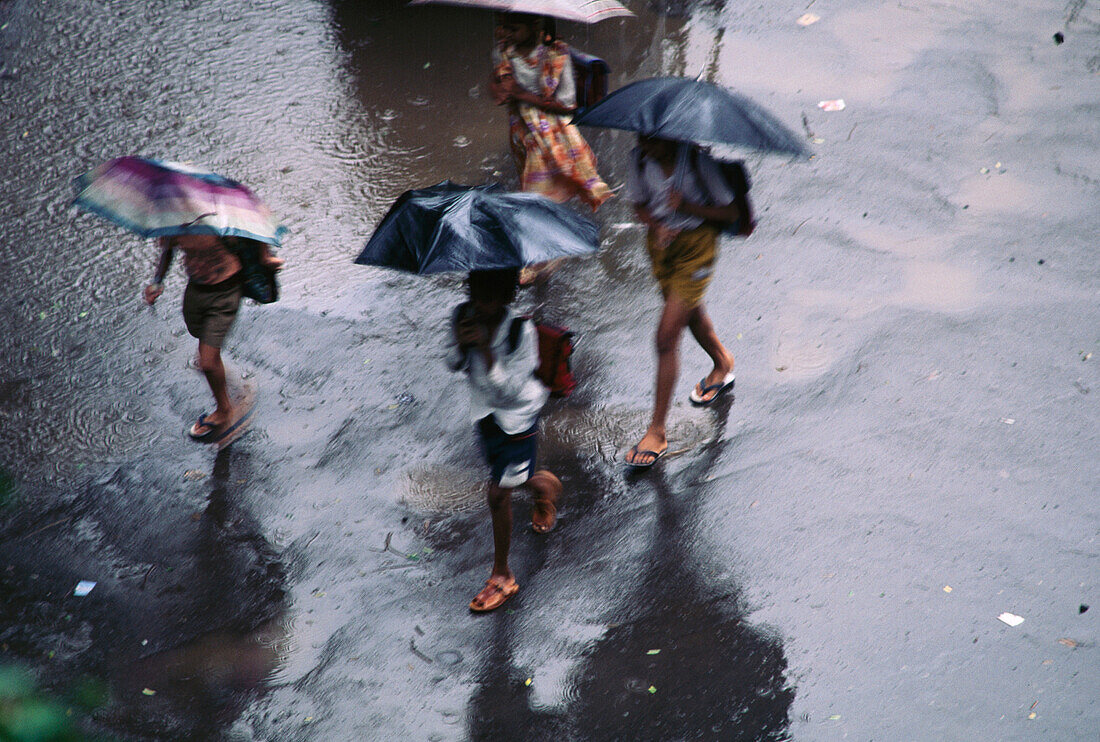 Children going to school during monsoon. Bombay. India