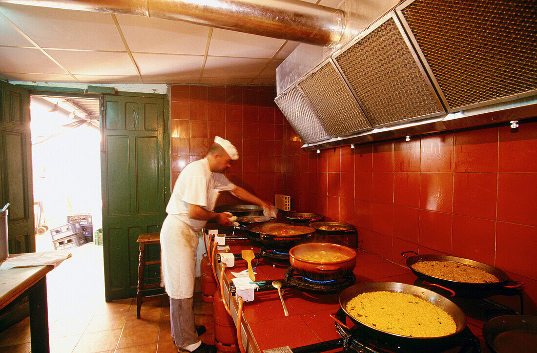 Cooking paella at La Genuina restaurant. Valencia. Spain