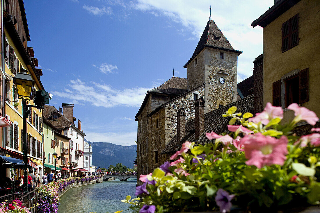 The Palais (palace) de l Ile, the Thiou river and the flowers of the riverside. Annecy. France.
