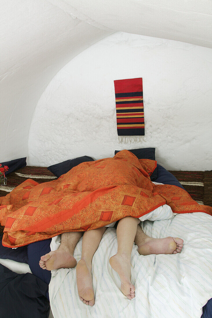 Couple in a loving attitude in a room of the igloo hotel. Hotel Kakslauttanen. Lapland. Ivalo. Finlandia