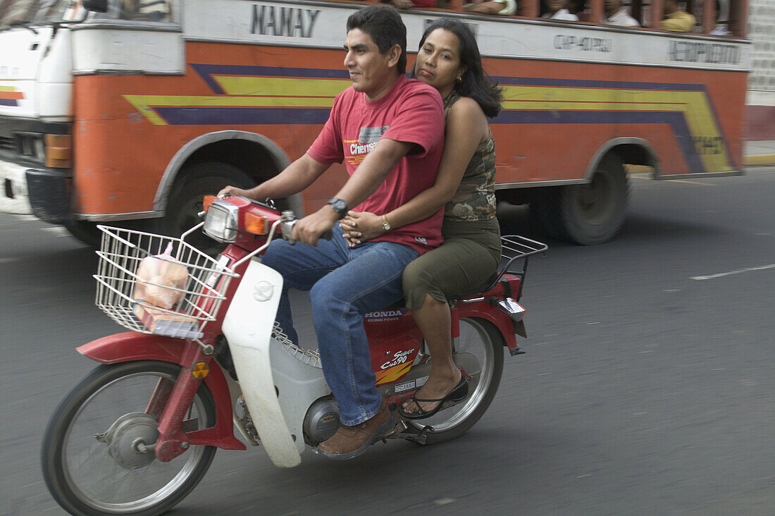 Couple on a bike. Iquitos. Peru