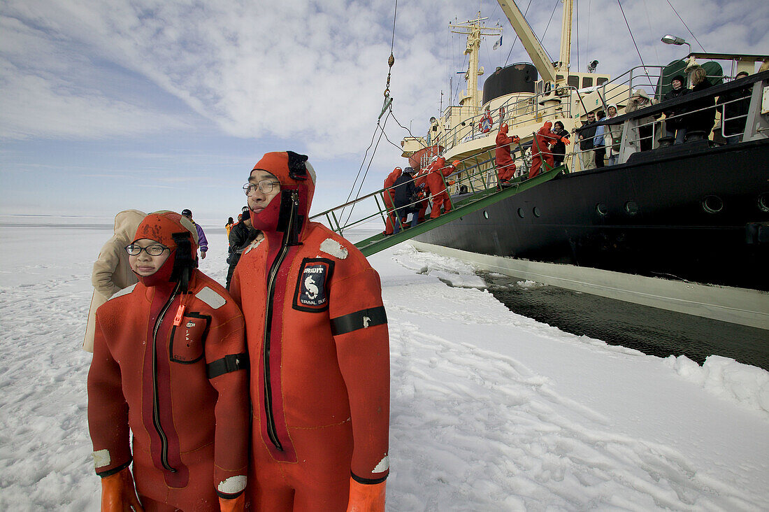 Asiatic tourists with special diving costumes for the iced Baltic Sea. Sampo Icebreaker. Kemi. Gulf of Bothnia. Baltic Sea. Finland.