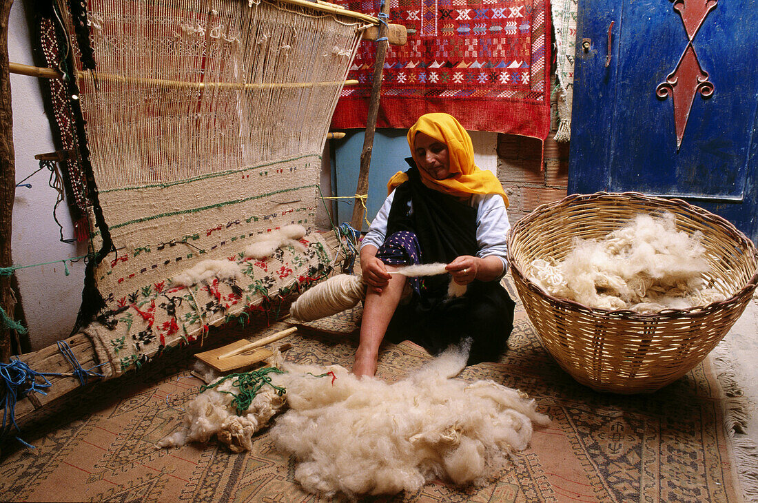 Woman weaving carpets. Tinerghir. Todra Valley. South Morocco
