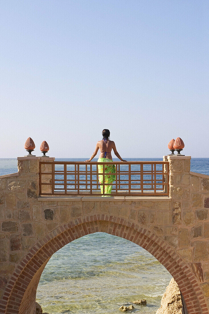 Woman Standing on Bridge in Holiday Resort in Swimming Costume, Red Sea, Egypt.