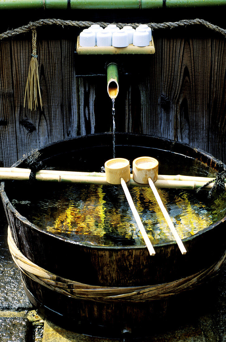Fountain and wooden water dippers. Kyoto. Japan