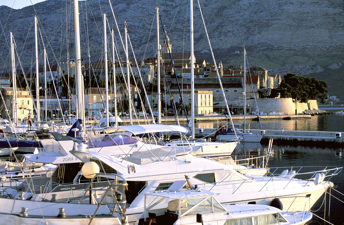 Boats at marina and the fortified town in background. Korcula Island. Croatia