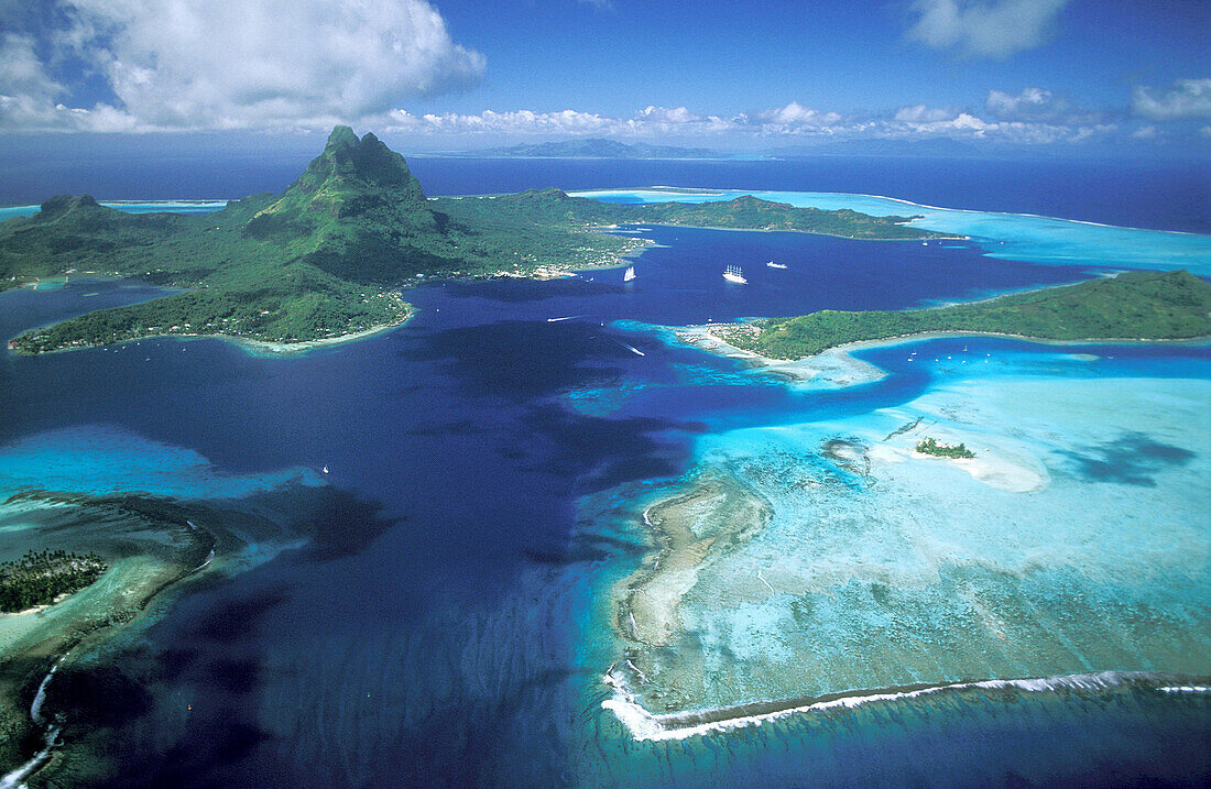Aerial of lagoon and Bora Bora island, Leeward Islands. French Polynesia