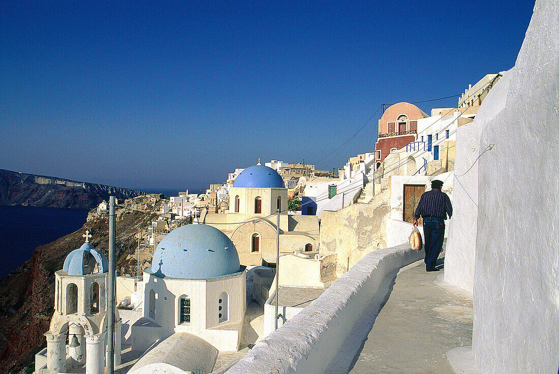 Man in a path at Ia village. Santorini. Cyclades. Greece