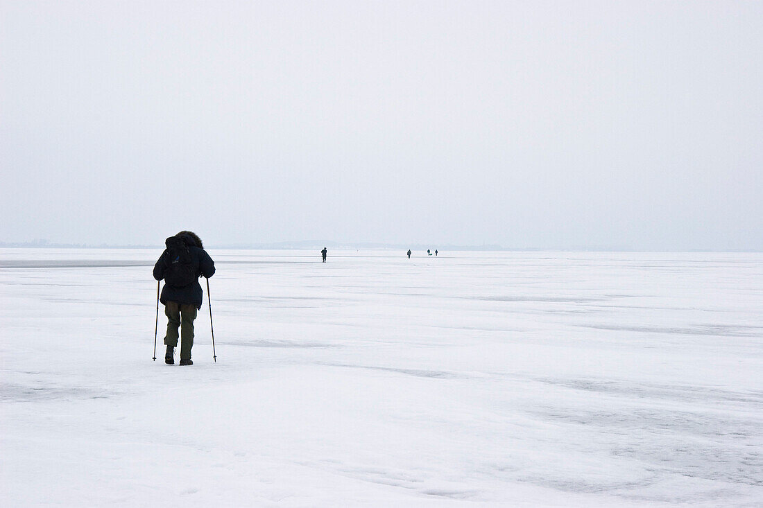 Persons walking on ice, Usedom Island, Mecklenburg-Western Pomerania, Germany