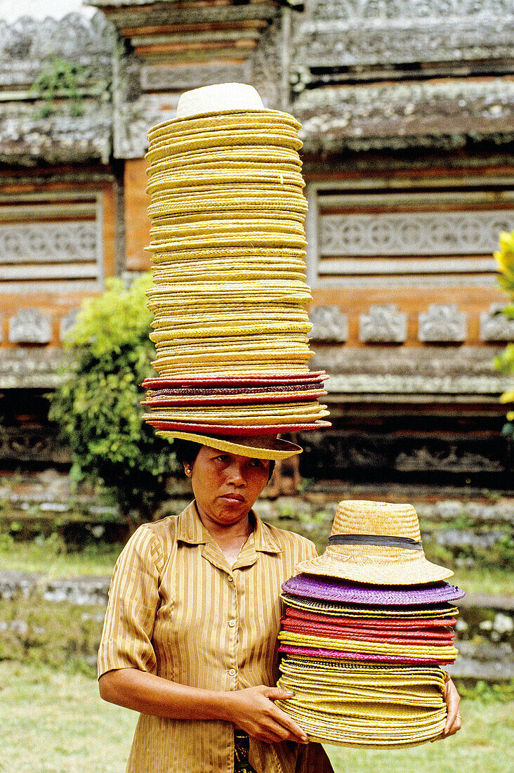 Hats seller in a temple. Bali island. Indonesia (model released)