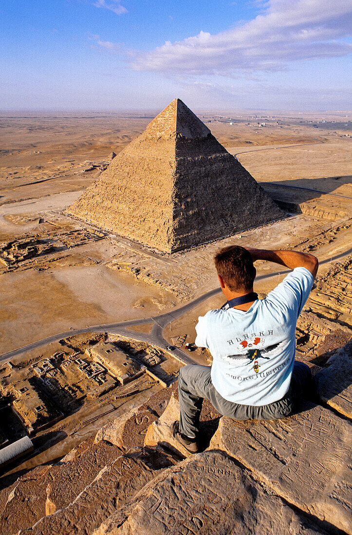 Climbing on the pyramids (which is strictly forbidden and dangerous...). Gizeh (Cairo suburbs). Egypt