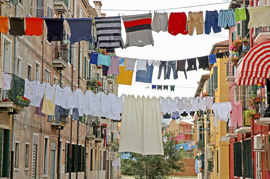 Drying laundry in a Giudecca Island popular street. Venice. Italy