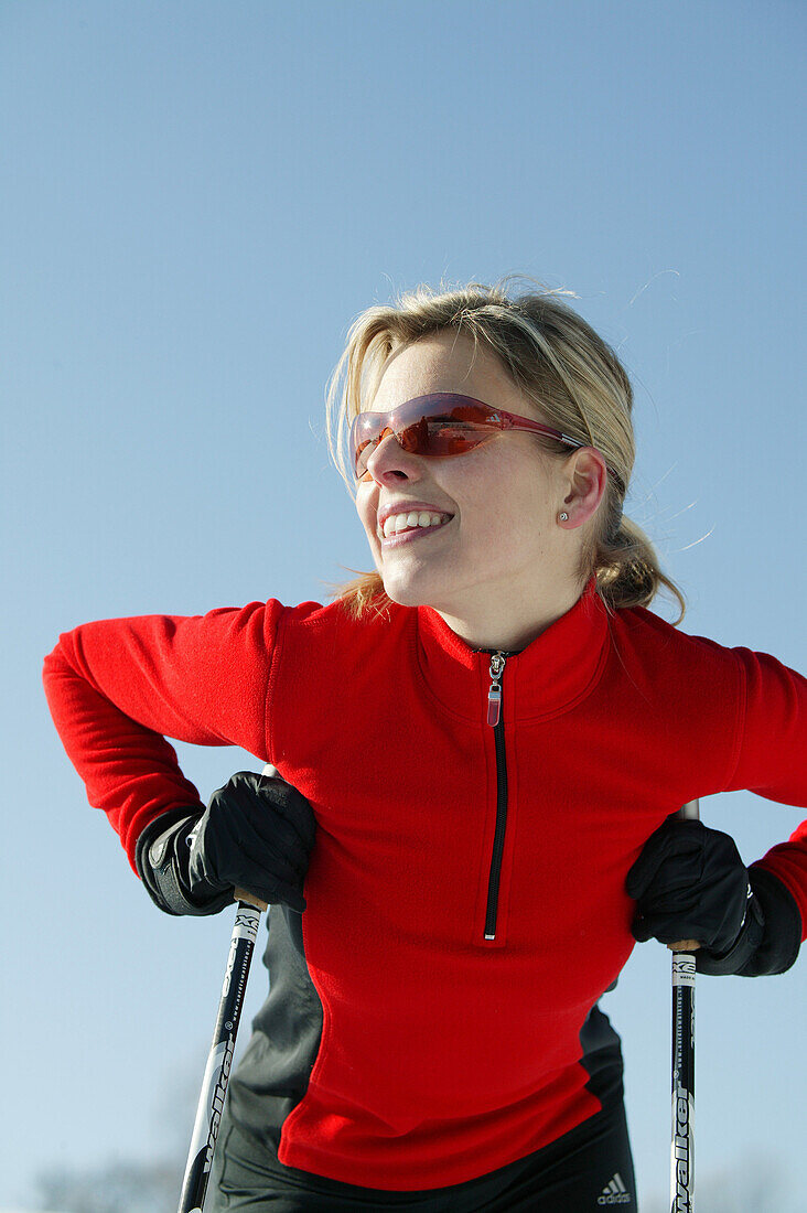 Woman leaning on ski poles, Styria, Austria