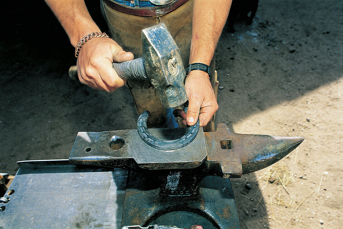 Repairing a horseshoe at ranch. Colorado. USA