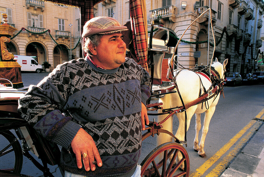 Malta. Valletta. Karrozzin (typical horse-drawn cab) driver waiting