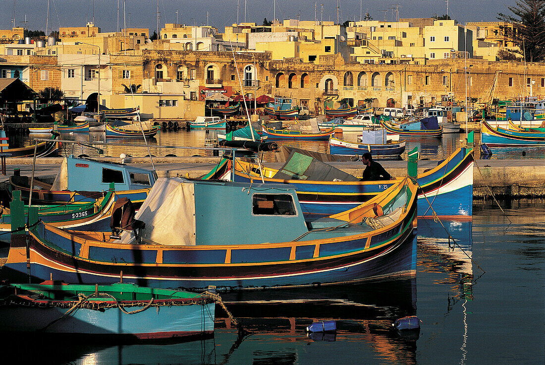 Marsaxlokk fishermen harbour at dusk. Malta