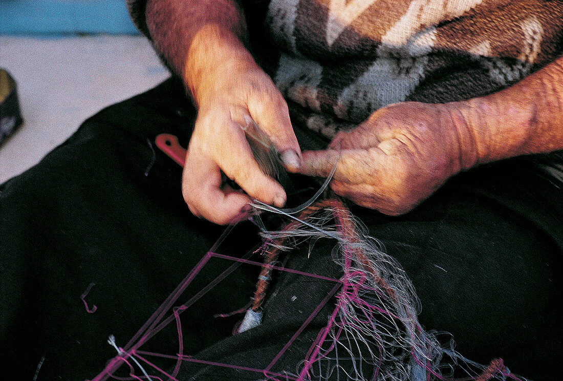 Fisherman mending net. Marsaxlokk. Malta