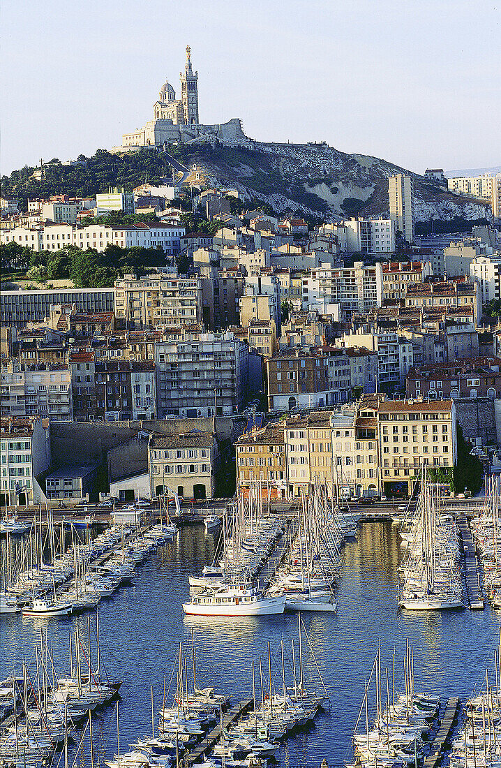 Old harbour. Church of Notre Dame de la Garde on the top of the hill. Marseille. France