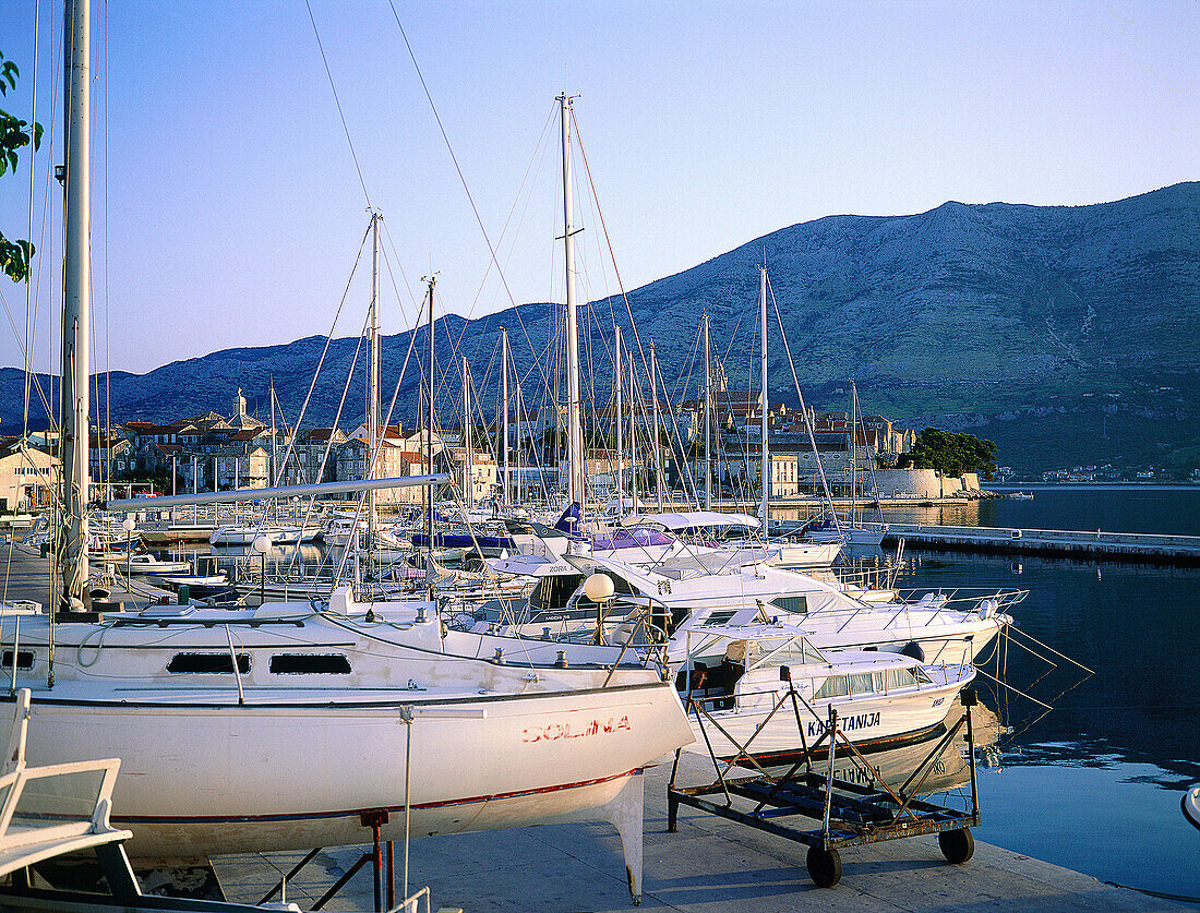 Boats at marina and the fortified town in background. Korcula Island. Croatia