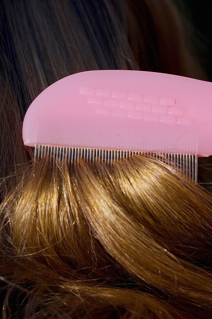 Nit comb running through hair